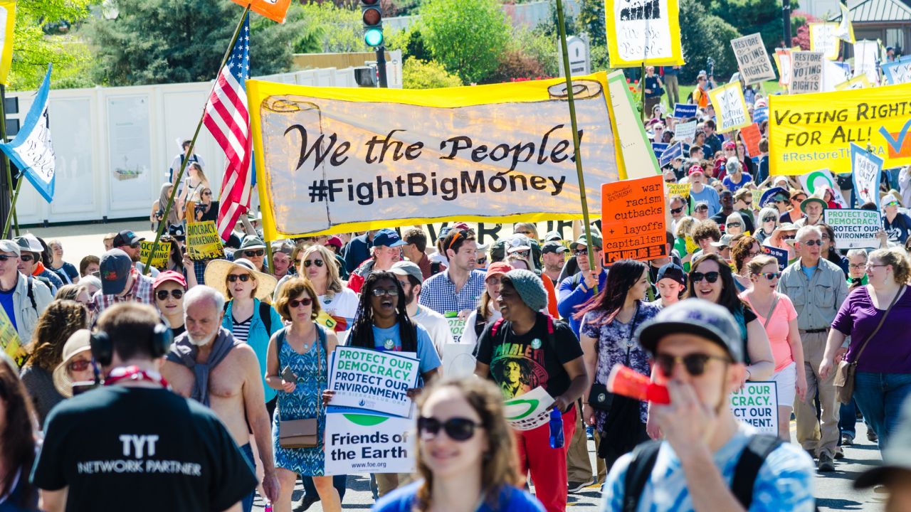 Demonstration sign saying We the People #FightBigMoney